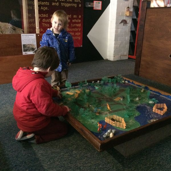 They had a small play area upstairs with sand to 'excavate fossils' and a dino play set.