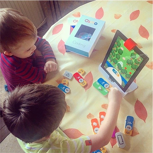 The boys playing with their coding app Osmo.
